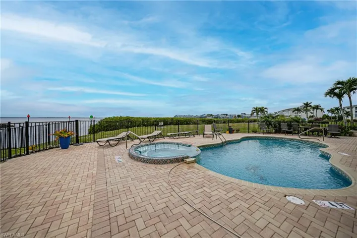View of swimming pool featuring a patio area and a community hot tub
