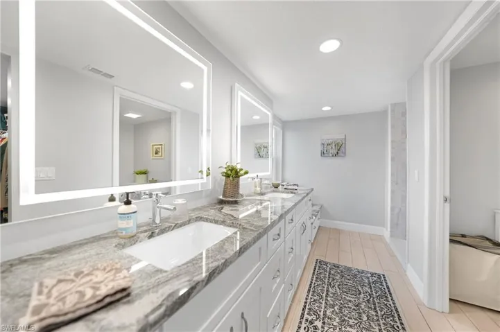 Bathroom with hardwood / wood-style floors and vanity
