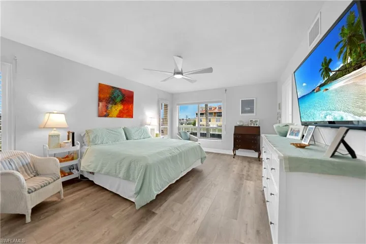 Bedroom with ceiling fan and light wood-type flooring