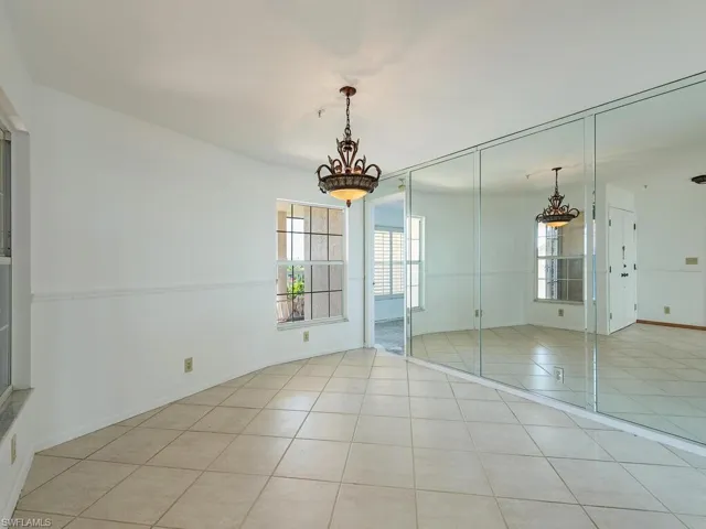 Unfurnished bedroom featuring a closet and light tile patterned floors