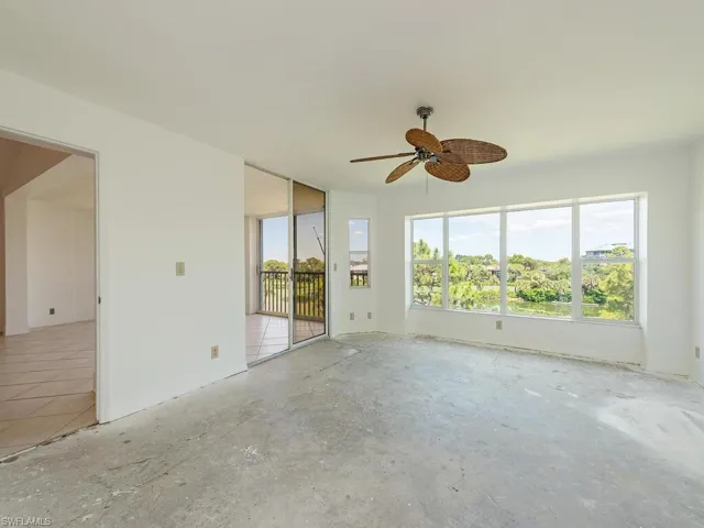 Empty room featuring concrete flooring and ceiling fan