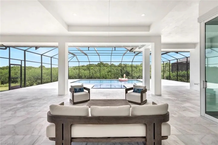 View of patio / terrace featuring a lanai, an outdoor living space, and an outdoor pool