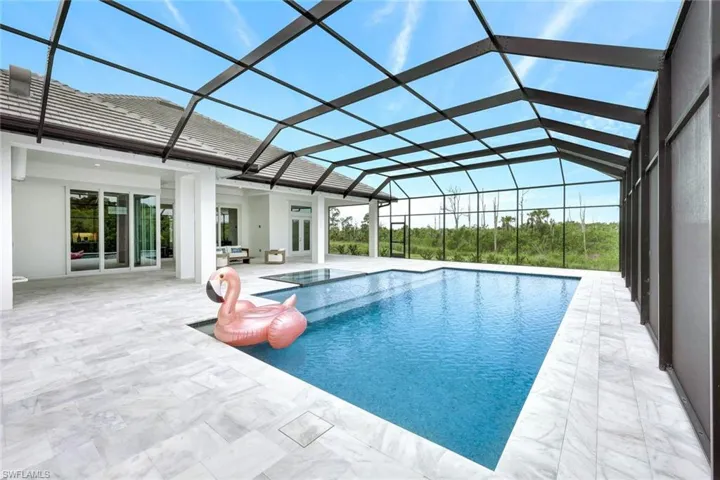 Outdoor pool with french doors, a patio, and a lanai