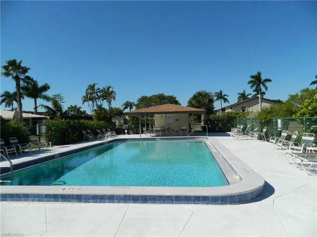 Community pool with a patio