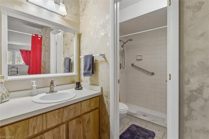 Bathroom with a shower stall and vanity