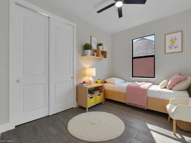 Bedroom featuring wood finished floors, ceiling fan, and a closet