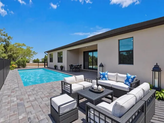 View of swimming pool featuring an outdoor living / dining area and patio surround