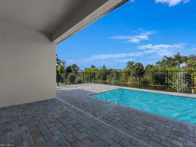 View of pool featuring patio surround and a fenced backyard