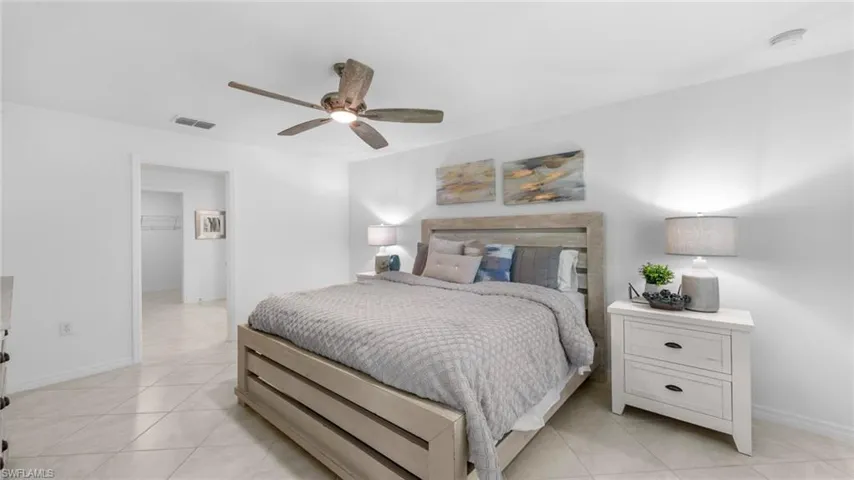 Bedroom featuring light tile patterned flooring and ceiling fan