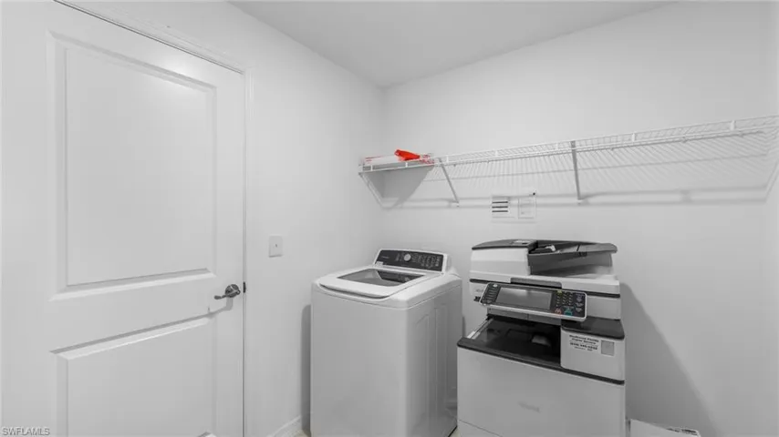 Laundry room featuring washer / clothes dryer and baseboards