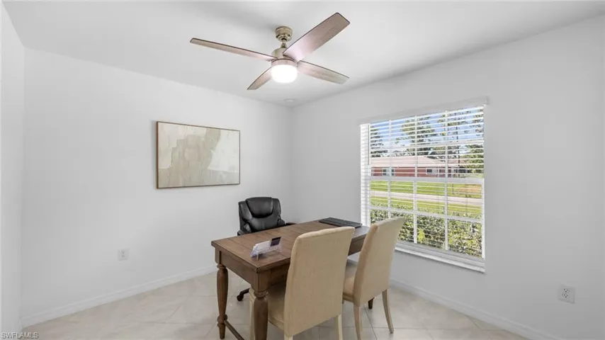 Office space with light tile patterned flooring and ceiling fan