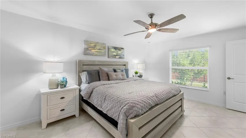 Bedroom featuring light tile patterned flooring and a ceiling fan