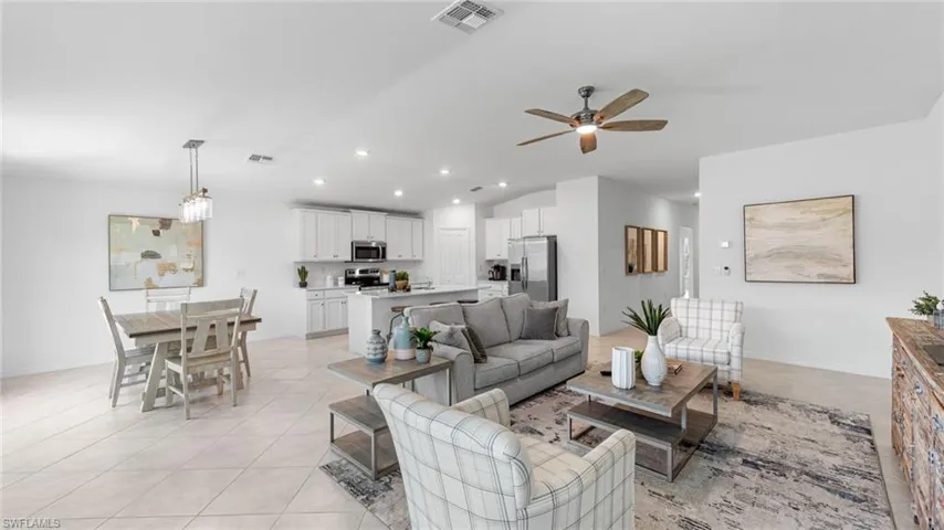 Living room featuring recessed lighting, light tile patterned floors, and ceiling fan