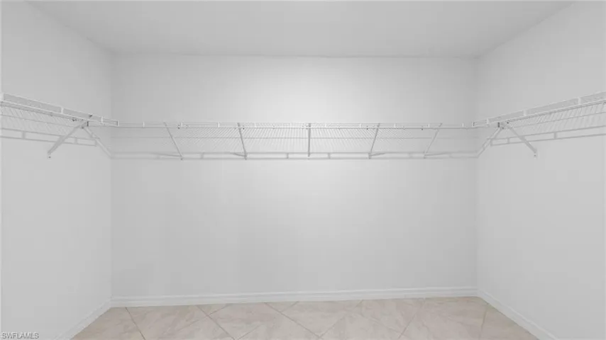 Spacious closet featuring light tile patterned floors