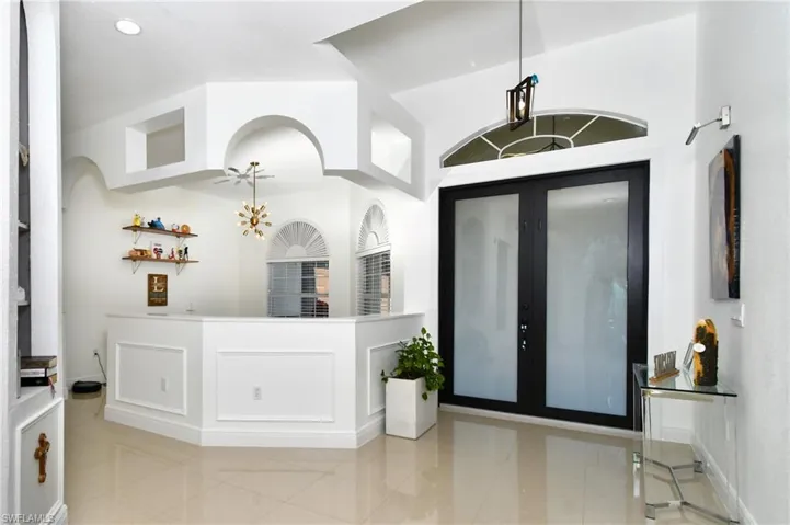 Foyer entrance featuring wet bar and french doors