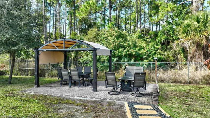 View of yard featuring a patio and outdoor dining space