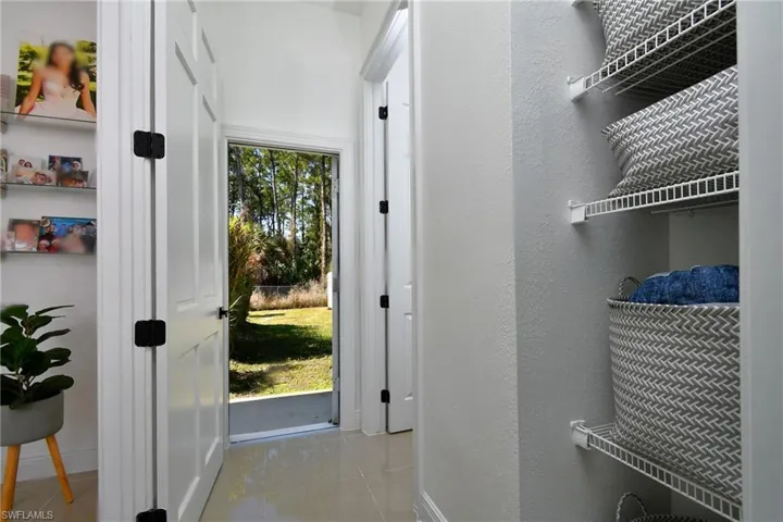 Doorway to outside featuring a textured wall and tile patterned flooring