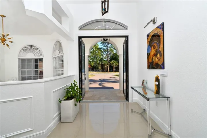Entrance foyer featuring baseboards and a textured wall