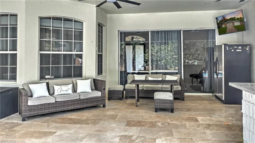 View of patio with ceiling fan and outdoor lounge area