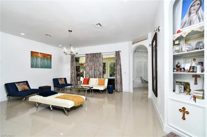 Living room featuring arched walkways and suspended lighting
