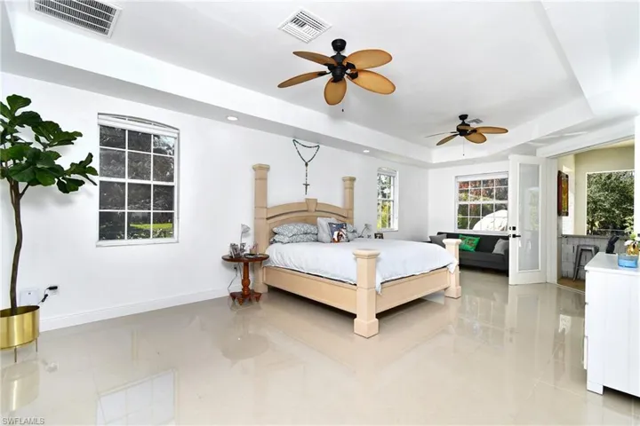 Bedroom featuring a raised ceiling and recessed lighting