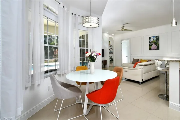 Dining area featuring arched walkways and a ceiling fan