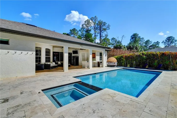 Combined pool / hot tub featuring outdoor furniture and a patio