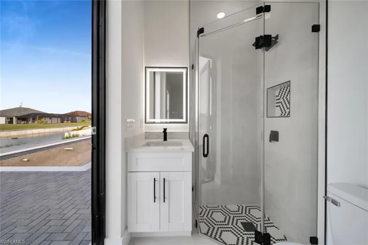 Full bath with vanity and a shower stall