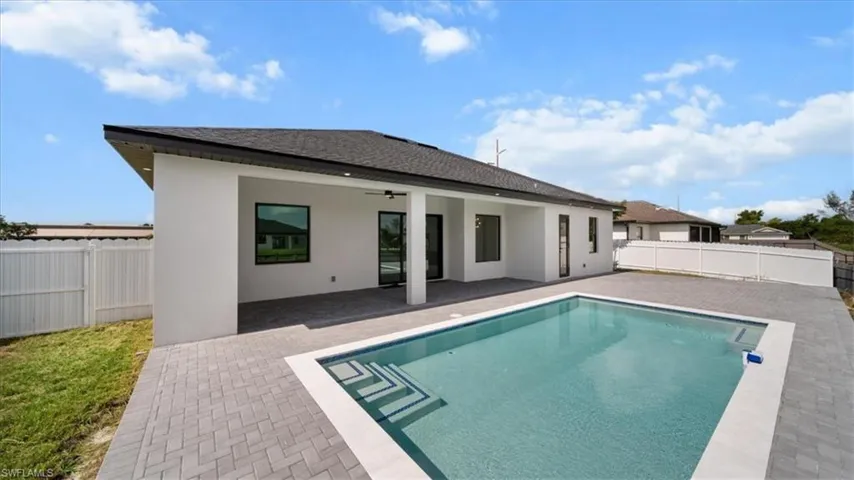 Back of property with a fenced backyard, a patio, stucco siding, and a shingled roof