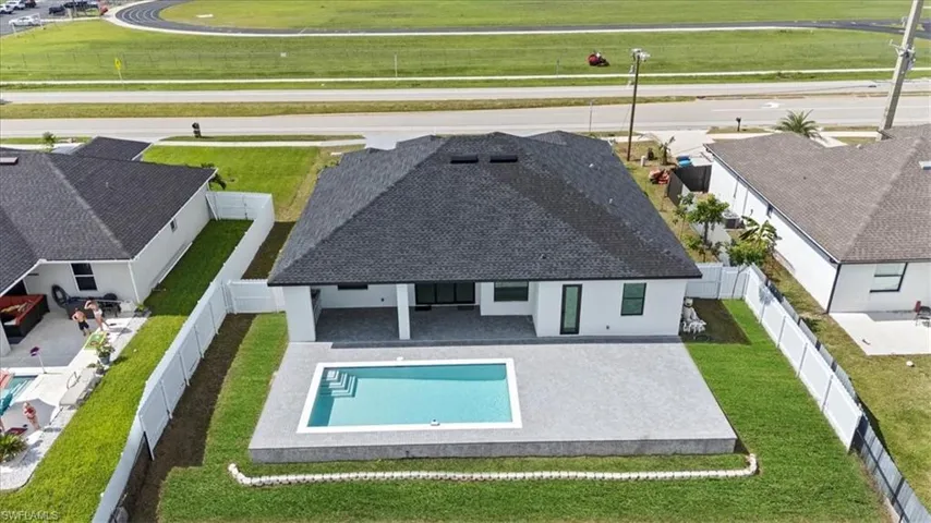 Aerial view of property and surrounding area featuring a pool area