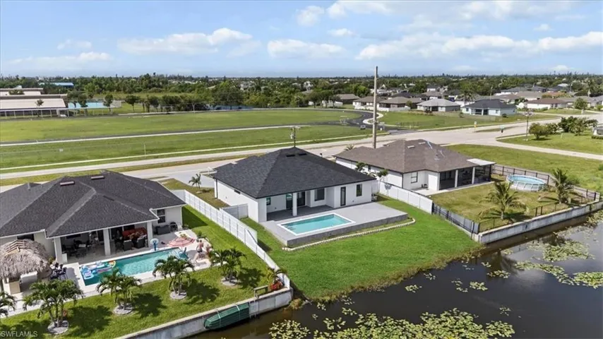 Aerial perspective of suburban area with a nearby body of water