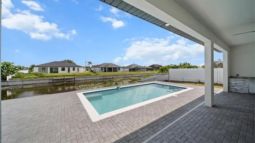 View of pool with a patio area, a residential view, and a fenced backyard