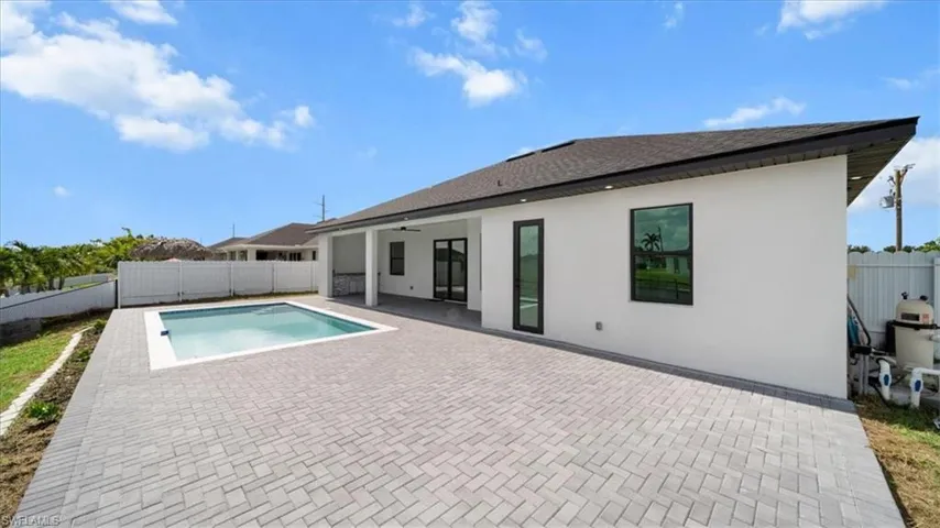 View of swimming pool with a patio area and a fenced backyard