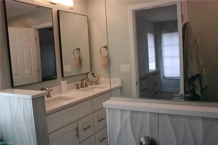 Dual vanity with undermount sinks, quartz countertops, and brushed nickel fixtures