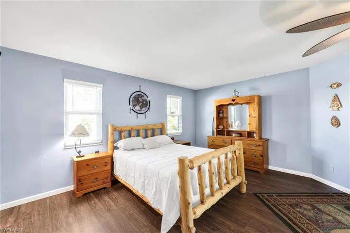Bedroom featuring dark wood finished floors and a ceiling fan