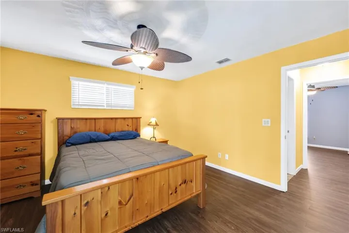 Bedroom featuring dark wood-type flooring and ceiling fan
