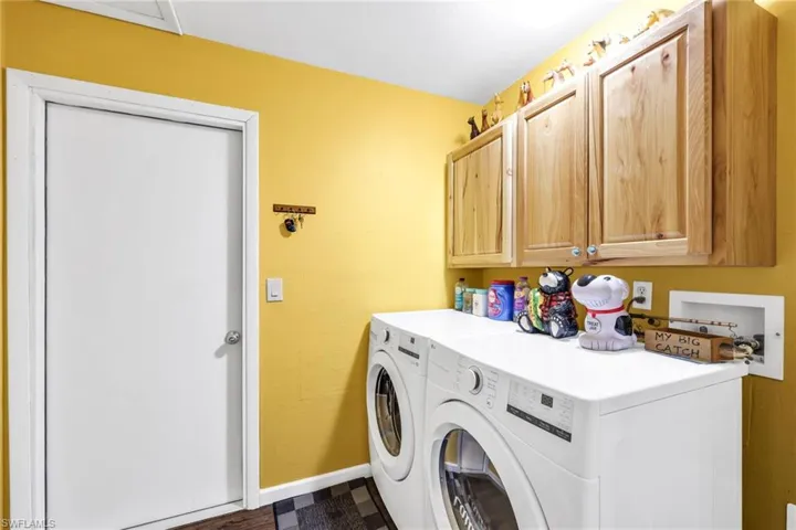 Washroom with washing machine and dryer and cabinet space