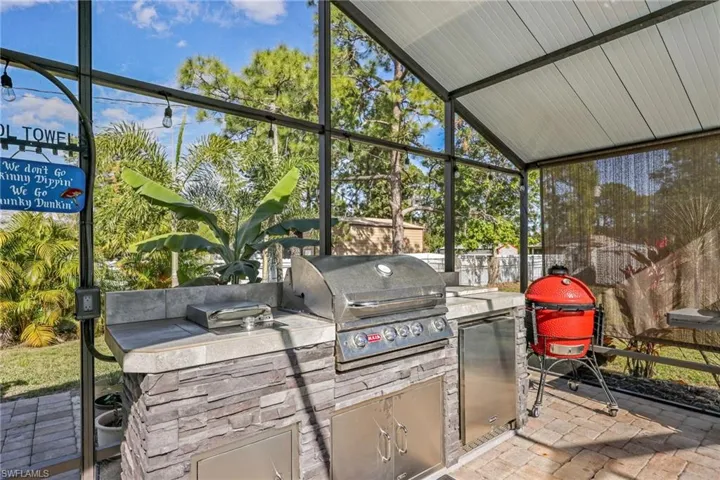 View of patio / terrace with area for grilling and a sunroom
