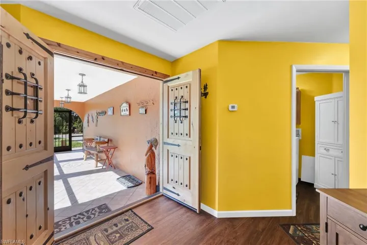 Entrance foyer featuring cooling unit and dark wood-type flooring