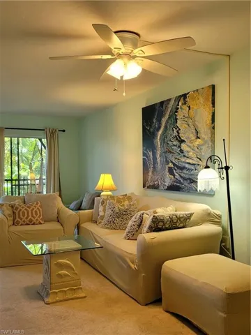 Living room featuring ceiling fan and carpet flooring