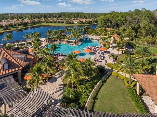 Birds eye view of property with a water view
