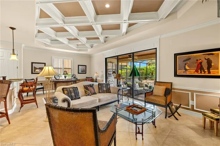 Living room with plenty of natural light, beamed ceiling, and coffered ceiling