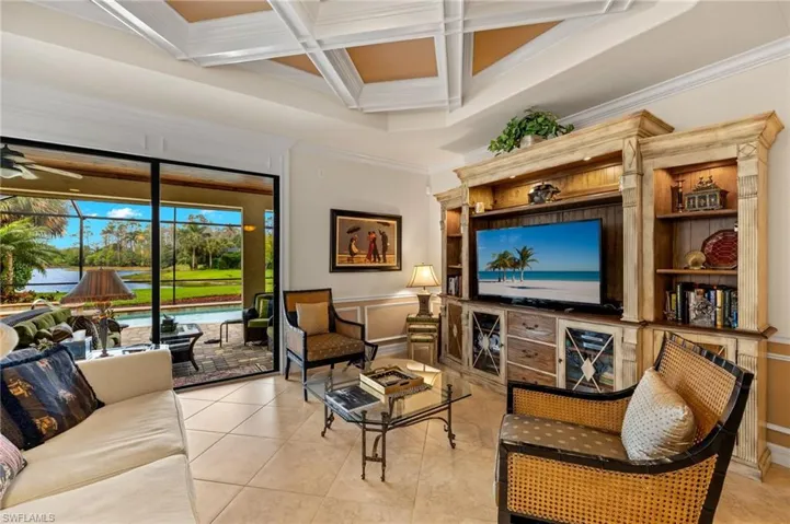 Living area featuring a ceiling fan, crown molding, coffered ceiling, and a sunroom