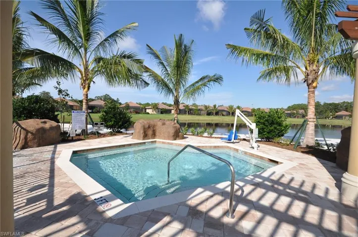 View of pool with a water view, a patio area, and a pool