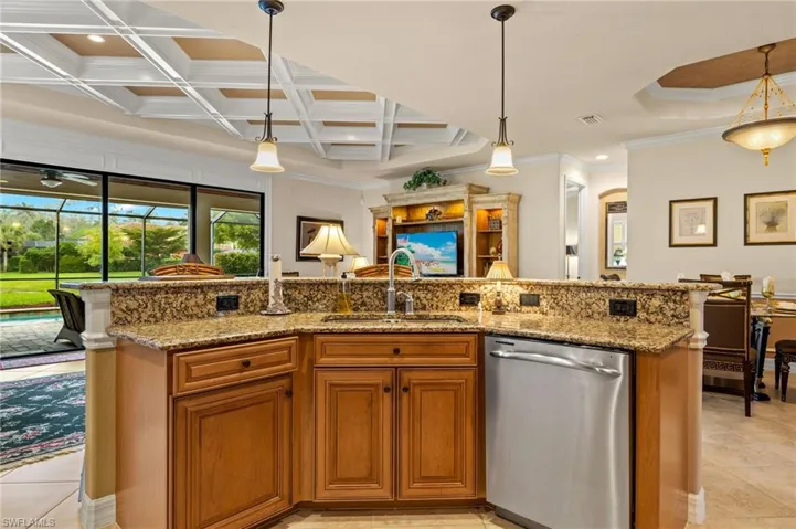 Kitchen with visible vents, open floor plan, dishwasher, coffered ceiling, and a sink