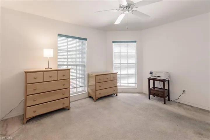 Sitting room featuring light carpet and ceiling fan