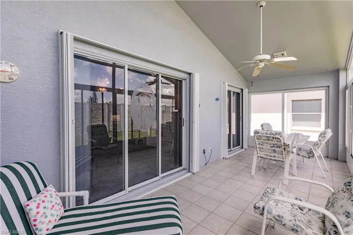 Sunroom / solarium featuring vaulted ceiling and ceiling fan