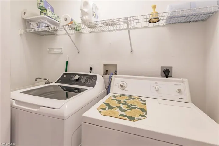 Clothes washing area featuring washing machine and dryer