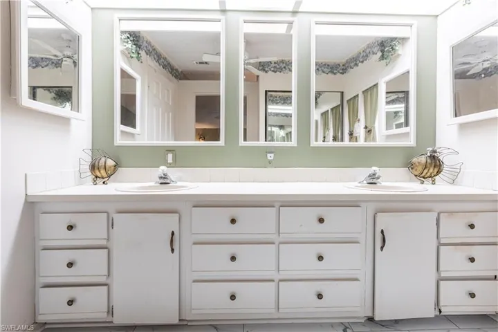 Full bathroom featuring double vanity and a sink