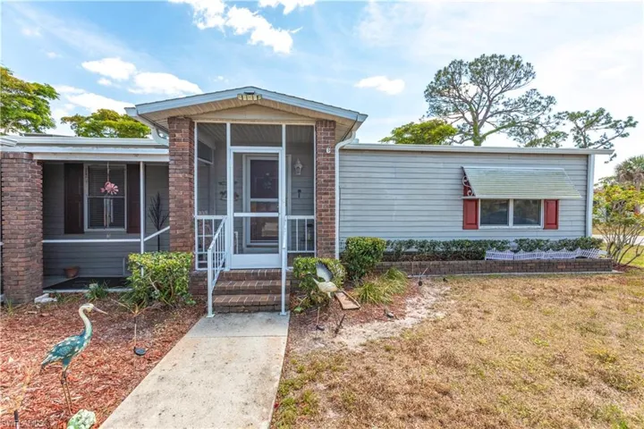 View of front of property featuring a front yard and a sunroom